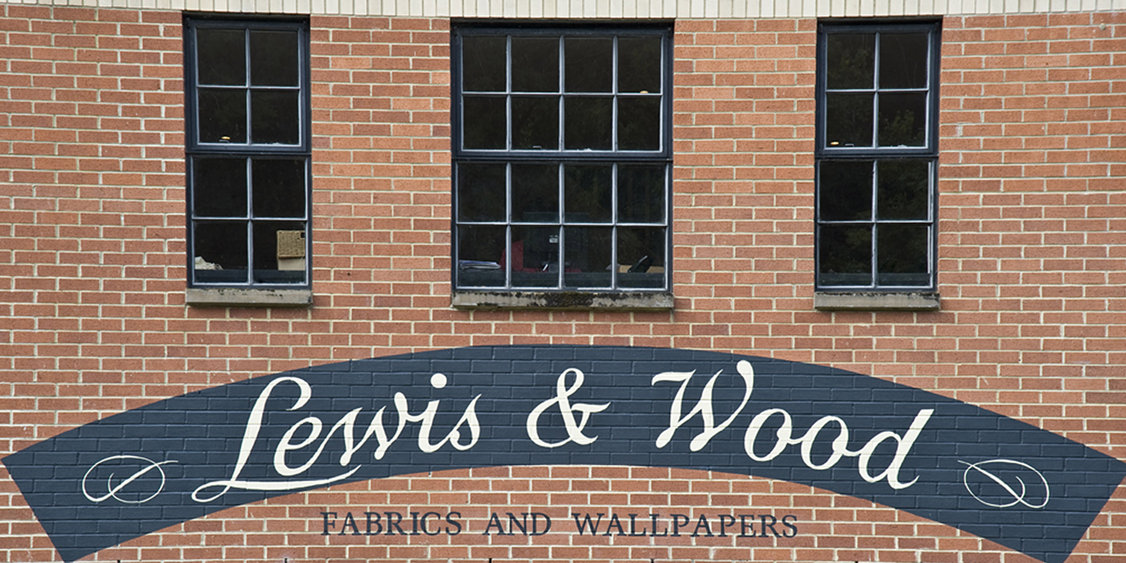 red brick front exterior of lewis and wood mill in england